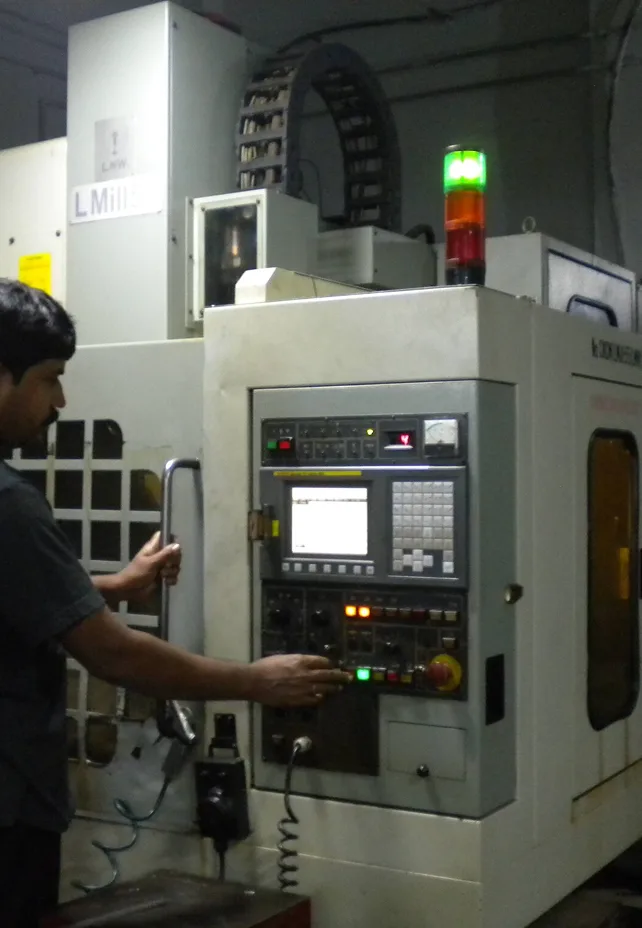 Operator running a CNC machining center on the shop floor